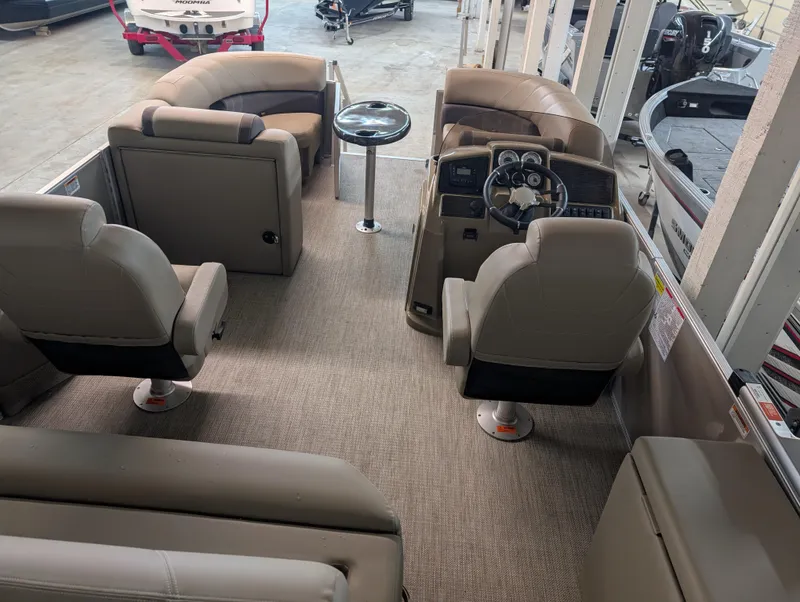 Slide: The Image of 2025 Sylvan Mirage Cruise 8520 CLZ DH interior with plush seating and modern dashboard. - 7