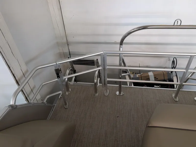 Slide: The Image of 2025 Sylvan Mirage Cruise 8520 CLZ DH boat interior with metal railings and seating. - 8