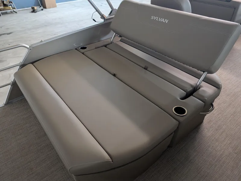 Slide: The Image of 2025 Sylvan Mirage Cruise 8520 CLZ DH boat seating with cup holders, gray upholstery. - 9