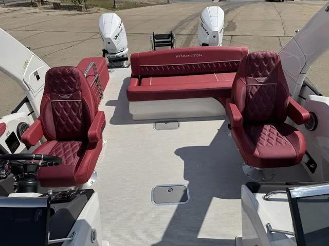 Slide: The Image of 2025 Bennington QX Swingback 30 QXSBWAX2 boat interior with red seating and sleek design. - 10