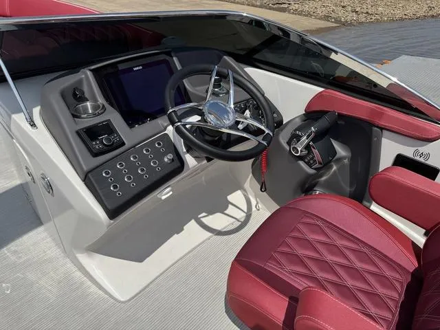 Slide: The Image of 2025 Bennington QX Swingback 30 QXSBWAX2 boat dashboard with steering wheel and controls. - 12