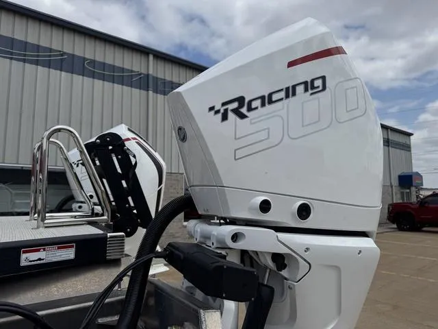 Slide: The Image of 2025 Bennington QX Swingback 30 QXSBWAX2 on water, featuring red seating and dual engines. - 4