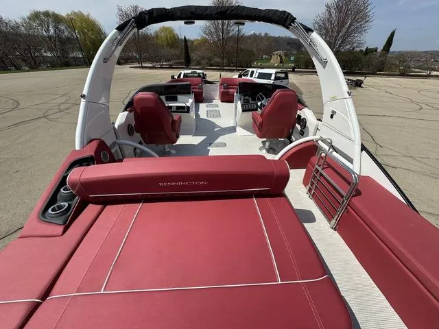 Slide: The Image of 2025 Bennington QX Swingback 30 QXSBWAX2 with red seating, dual engines on a calm lake. - 6