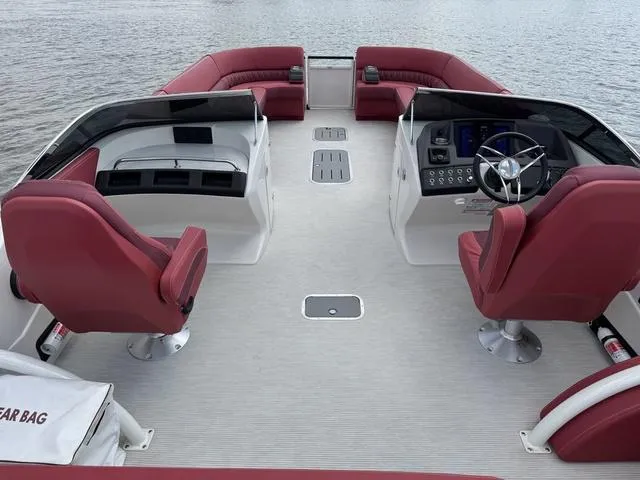 Slide: The Image of 2025 Bennington QX Swingback 30 QXSBWAX2 with luxurious red seating on a dock. - 7