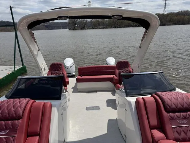 Slide: The Image of 2025 Bennington QX Swingback 30 QXSBWAX2 with luxurious red seating on a sunny day. - 8