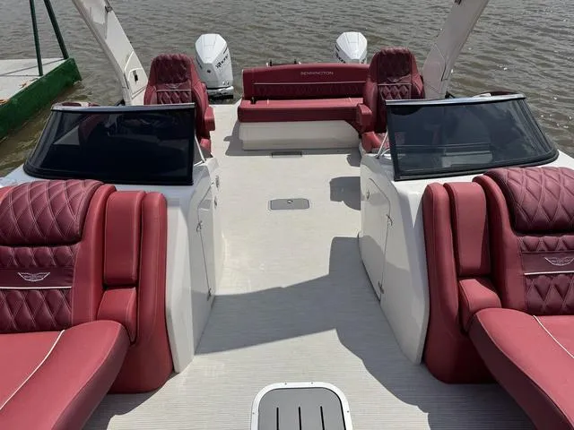 Slide: The Image of 2025 Bennington QX Swingback 30 QXSBWAX2 with luxurious red seating on a serene lake. - 9