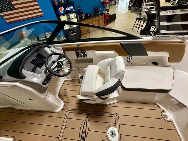 Slide: The Image of 2025 Chaparral 23 SSi boat interior with modern dashboard and comfortable seating. - 11