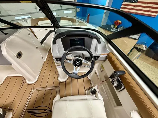 Slide: The Image of Interior view of 2025 Chaparral 23 SSi boat, featuring modern steering and dashboard. - 12
