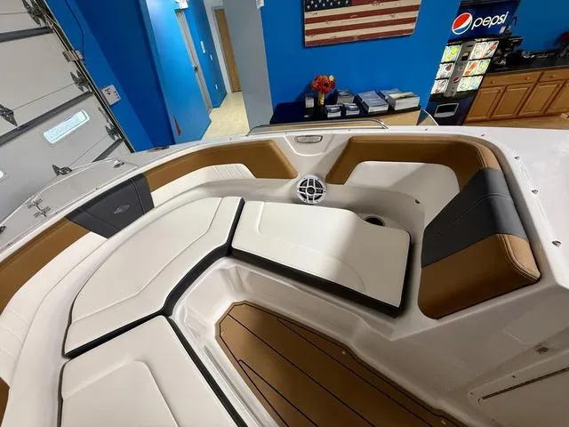 Slide: The Image of 2025 Chaparral 23 SSi boat interior with white and brown seating, American flag decor. - 15