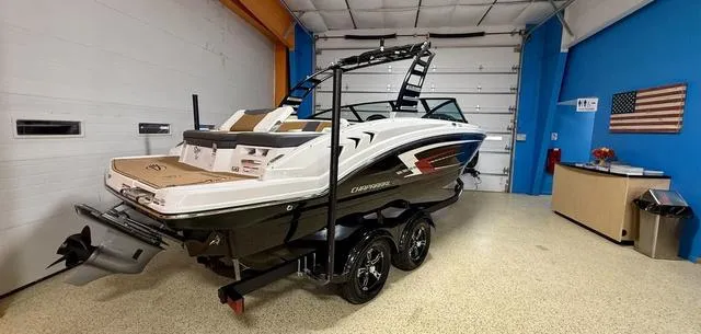 Slide: The Image of 2025 Chaparral 23 SSi boat in showroom, black and white design, on trailer. - 3
