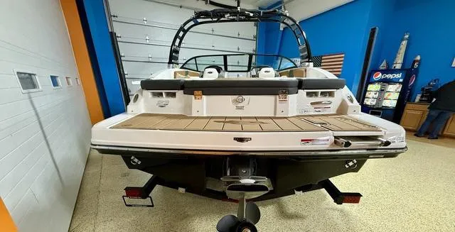 Slide: The Image of 2025 Chaparral 23 SSi boat in showroom, rear view, featuring sleek design and modern amenities. - 4