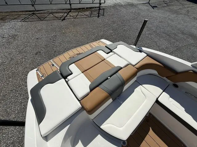 Slide: The Image of 2025 Chaparral 23 SSi boat with stylish tan and gray seating on deck. - 10