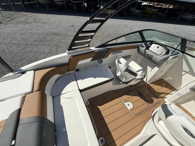 Slide: The Image of 2025 Chaparral 23 SSi boat interior with sleek seating and modern dashboard design. - 11