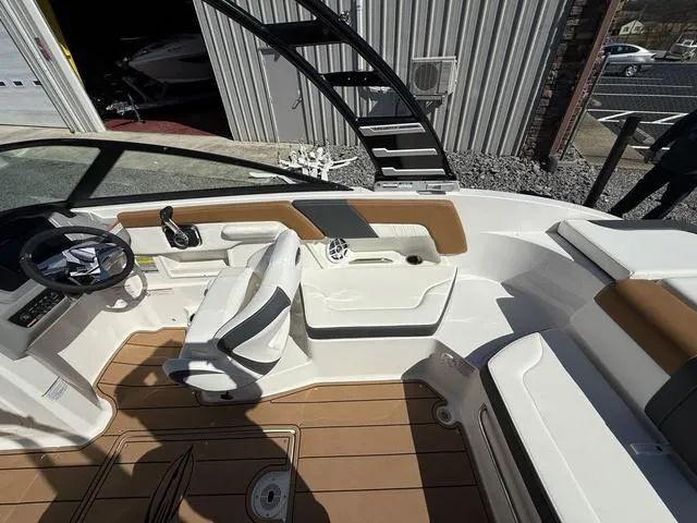 Slide: The Image of 2025 Chaparral 23 SSi boat interior with modern seating and steering wheel. - 12