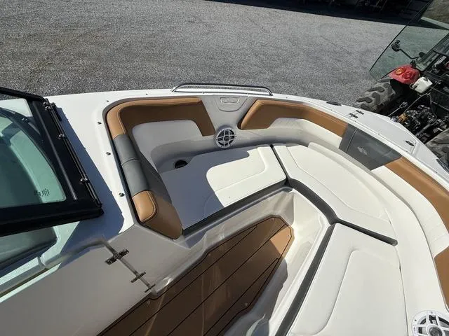 Slide: The Image of 2025 Chaparral 23 SSi boat interior with tan and white seating, open bow design. - 17