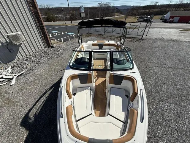 Slide: The Image of 2025 Chaparral 23 SSi boat with open bow seating, parked outdoors. - 19