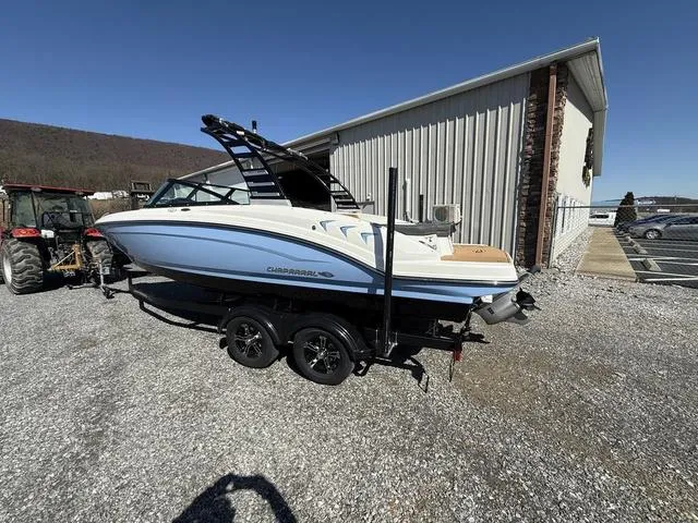 Slide: The Image of 2025 Chaparral 23 SSi boat on trailer, parked outdoors near a building. - 3