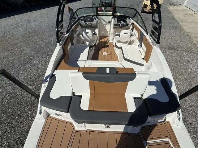 Slide: The Image of 2025 Chaparral 23 SSi boat interior with tan and white seating, sleek design. - 7