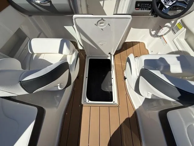 Slide: The Image of 2025 Chaparral 23 SSi boat interior with open storage compartment and seating. - 9