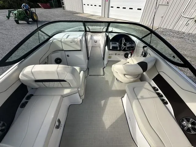Slide: The Image of 2022 Regal 22 FasDeck boat interior with white seating and modern dashboard. - 10