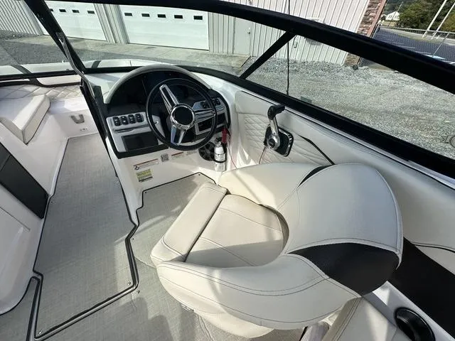 Slide: The Image of 2022 Regal 22 FasDeck boat interior with steering wheel and captain's seat. - 11