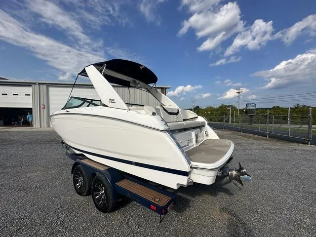 Slide: The Image of 2022 Regal 22 FasDeck boat on trailer under a partly cloudy sky. - 6