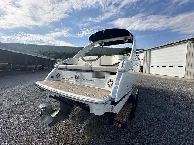 Slide: The Image of 2022 Regal 22 FasDeck boat with spacious seating, parked outdoors under a clear sky. - 8