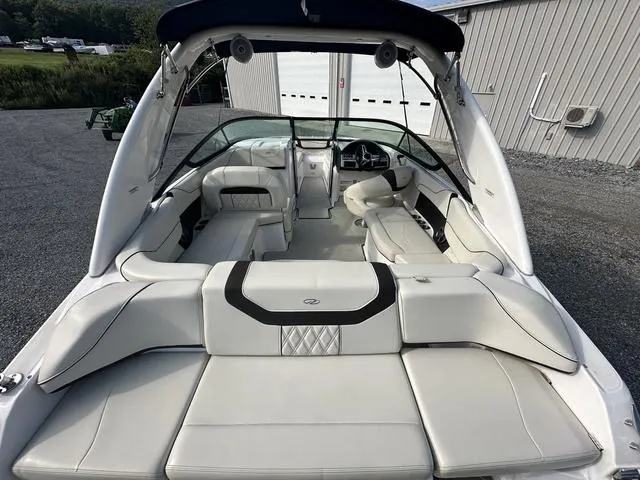 Slide: The Image of 2022 Regal 22 FasDeck boat interior with white seating and modern design. - 9