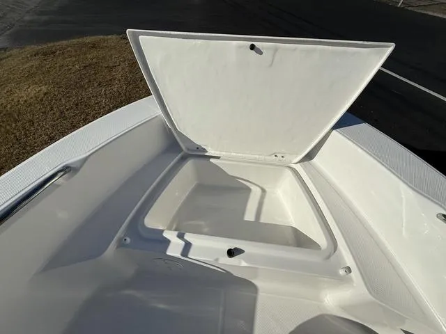 Slide: The Image of 2025 Robalo R160 boat storage compartment open, showcasing spacious interior design. - 12
