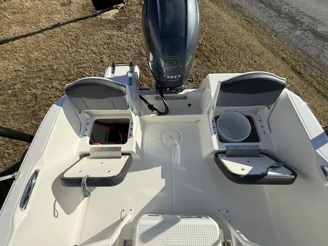 Slide: The Image of 2025 Robalo R160 boat interior with seating and outboard motor. - 8