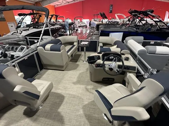 Slide: The Image of 2024 Bennington 22' SSB pontoon boat interior with beige and navy seating. - 15