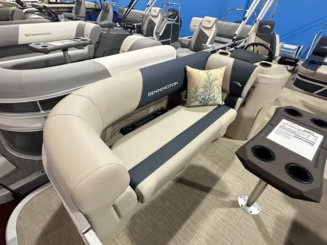 Slide: The Image of 2024 Bennington 22' SSB pontoon boat interior with beige seating and table. - 4