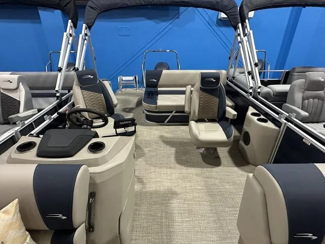 Slide: The Image of 2024 Bennington 22' SSB pontoon boat interior with seating and steering console. - 6