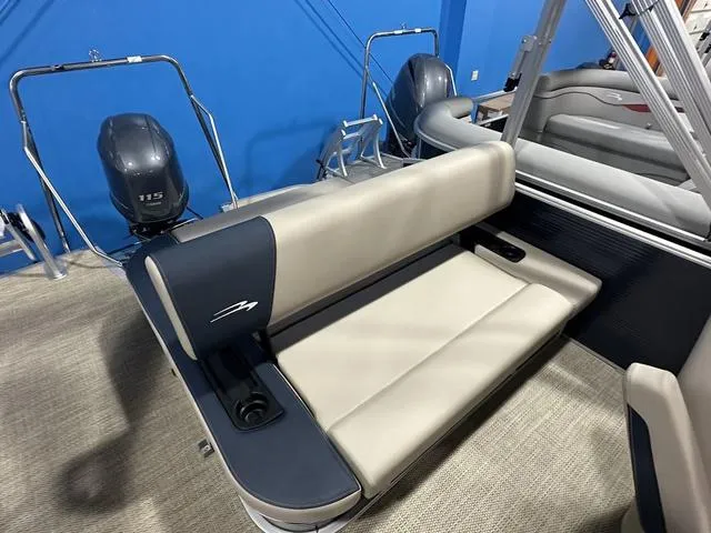 Slide: The Image of 2024 Bennington 22' SSB boat interior with beige and navy seating, dual outboard motors. - 9