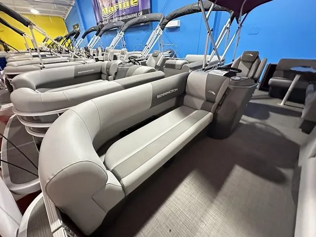 Slide: The Image of 2024 Bennington 188 SVL pontoon boat with spacious seating in showroom. - 4