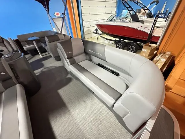 Slide: The Image of 2024 Bennington 188 SVL pontoon boat interior with gray seating in showroom. - 5