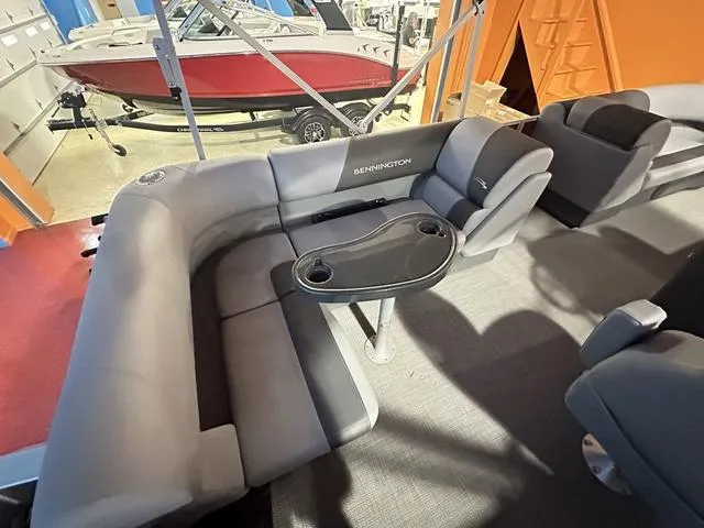 Slide: The Image of 2024 Bennington 188 SVL pontoon boat interior with gray seating and a central table. - 6
