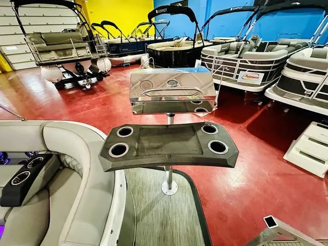Slide: The Image of 2023 Bennington 25 RXSBA pontoon boat interior with cup holders and seating. - 12