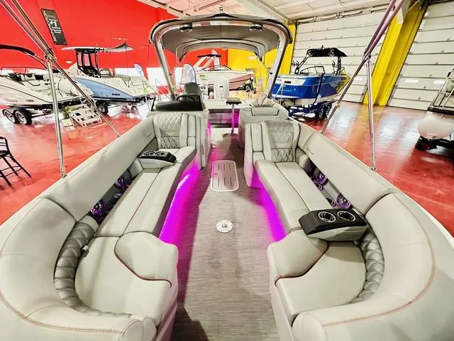 Slide: The Image of 2023 Bennington 25 RXSBA pontoon boat interior with luxurious seating and ambient lighting. - 13