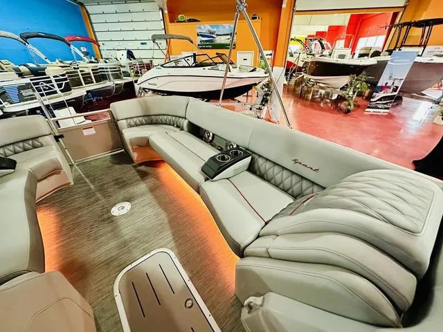 Slide: The Image of 2023 Bennington 25 RXSBA pontoon boat interior with luxurious seating in a showroom. - 15