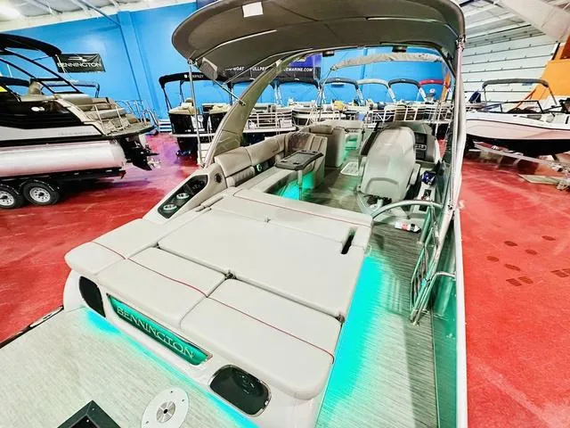 Slide: The Image of 2023 Bennington 25 RXSBA pontoon boat with spacious seating and modern design in showroom. - 19