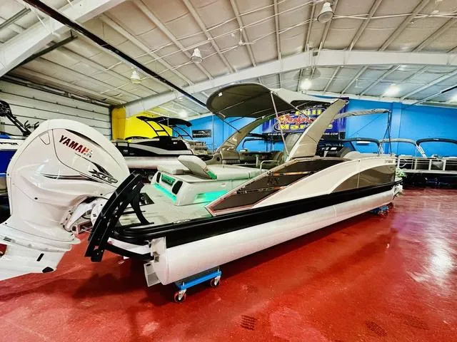Slide: The Image of 2023 Bennington 25 RXSBA pontoon boat with Yamaha engine in showroom. - 2