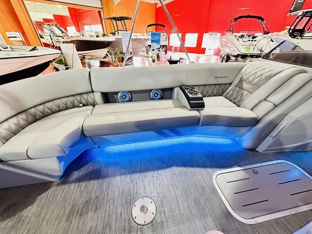 Slide: The Image of 2023 Bennington 25 RXSBA boat interior with luxurious seating and blue LED lighting. - 22