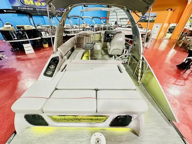 Slide: The Image of 2023 Bennington 25 RXSBA pontoon boat with spacious seating and modern design in showroom. - 24