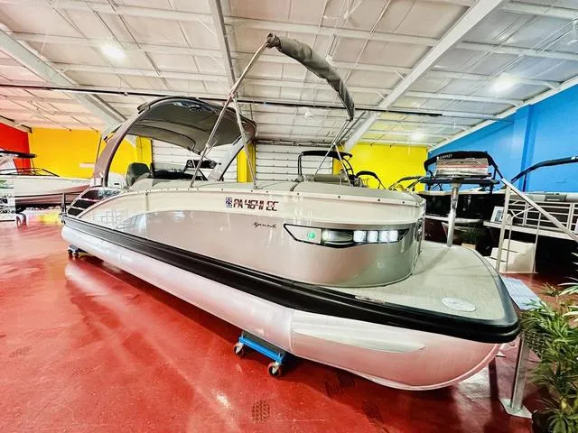 Slide: The Image of 2023 Bennington 25 RXSBA pontoon boat displayed in a vibrant showroom. - 8