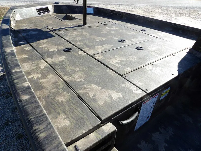 Slide: The Image of 2025 Crestliner XFC 189 boat deck with camouflage pattern, featuring storage compartments. - 10