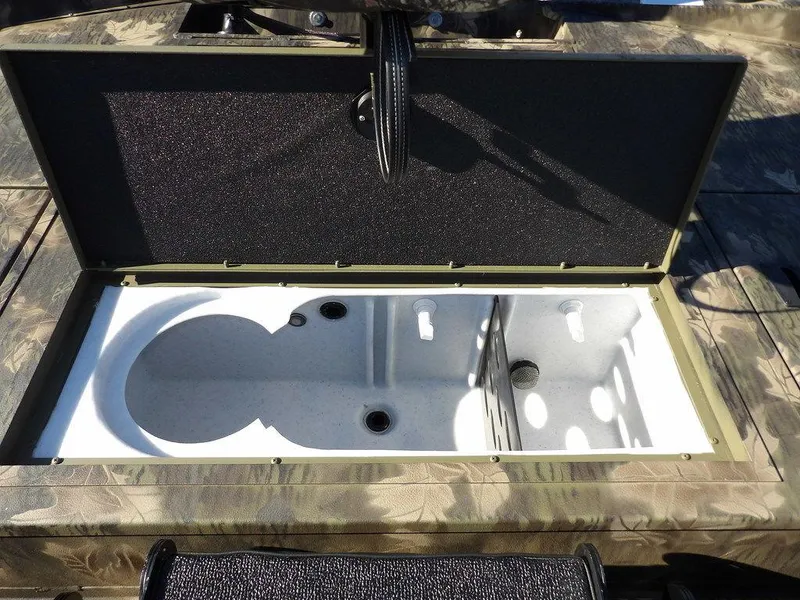 Slide: The Image of 2025 Crestliner XFC 189 livewell compartment, open lid, camo design. - 13