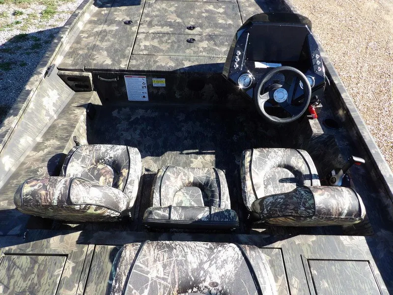 Slide: The Image of 2025 Crestliner XFC 189 boat interior with camouflage seats and steering console. - 15