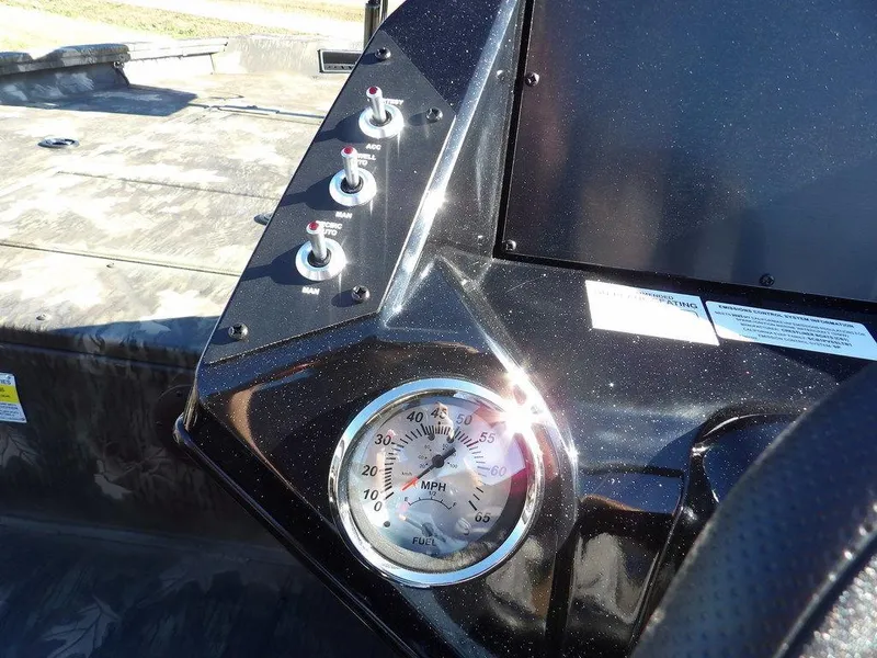 Slide: The Image of 2025 Crestliner XFC 189 boat dashboard with speedometer and control switches. - 17