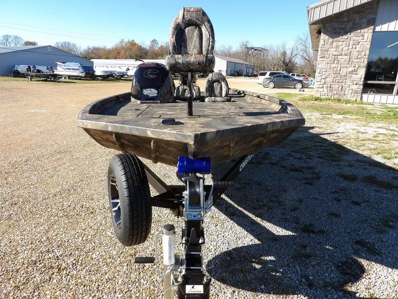 Slide: The Image of 2025 Crestliner XFC 189 boat on trailer, camo seats, outdoor setting. - 2